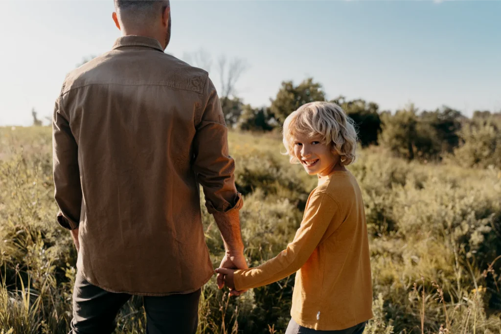 close up father kid holding hands