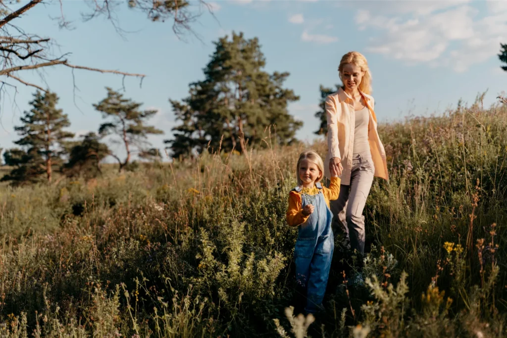 full shot mother girl holding hands