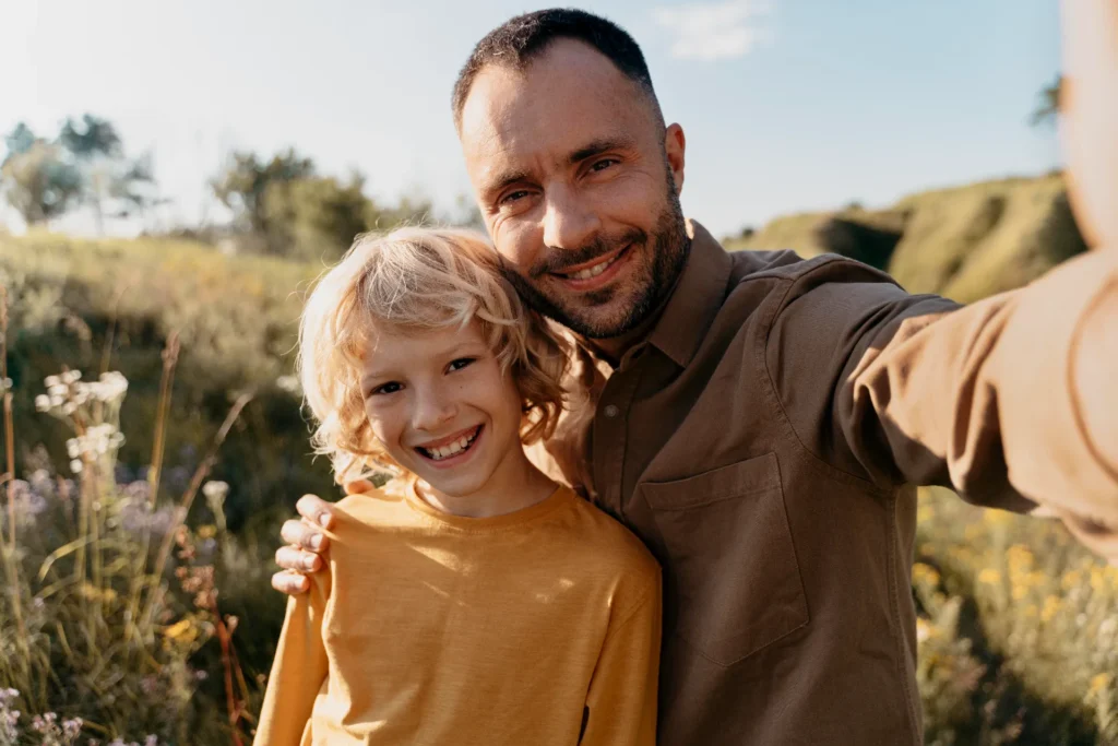 medium shot father kid taking selfie